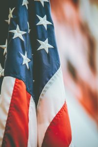 Detailed close-up of the American flag showing stars and stripes, symbolizing patriotism and freedom.